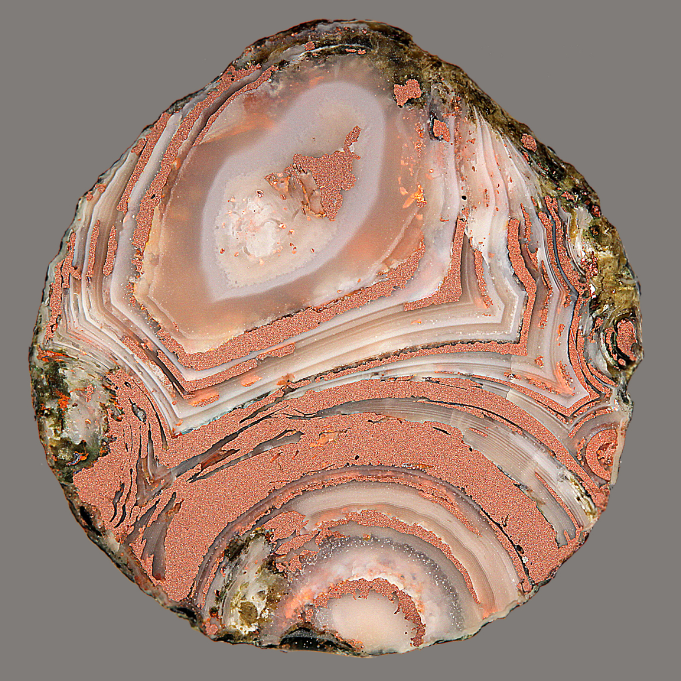 Round small pebble of white quartz and copper banded. Green rind around rim.